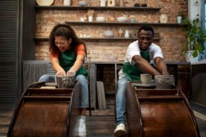 Two persons doing pottery work